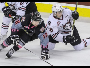 Calgary Hitmen Jakob Stukel and Red Deer Rebels Grayson Pawlenchuk get tangled up in WHL action at the Scotiabank Saddledome in Calgary, Alberta, on Sunday, March 6. The Hitmen lost to the Rebels 4-3. Mike Drew/Postmedia