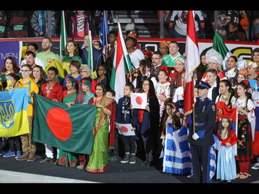 Members of the Calgary community representing over 20 countries took to the ice for Multicultural Night before the game between the Calgary Hitmen and the Red Deer Rebels in WHL action at the Scotiabank Saddledome in Calgary, Alberta, on Sunday, March 6. Mike Drew/Postmedia