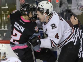 Jake Bean of the Hitmen and the Red Deer Rebels' Haydn Fleury knock heads just before the final whistle in WHL action at the Scotiabank Saddledome on Sunday night. The Hitmen lost to the Rebels 4-3.