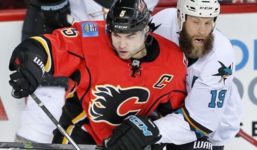 Calgary Flames Mark Giordano battles against Joe Thornton of the San Jose Sharks during NHL hockey in Calgary, Alta., on Monday, March 7, 2016. AL CHAREST/POSTMEDIA