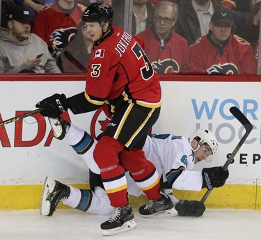 Calgary Flames Jyrki Jokipakka collides with Melker Karlsson of the San Jose Sharks during NHL hockey in Calgary, Alta., on Monday, March 7, 2016. AL CHAREST/POSTMEDIA