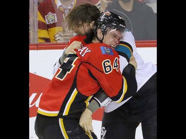 Calgary Flames Garnet Hathaway tangles with San Jose Sharks Brent Burns in NHL hockey action at the Scotiabank Saddledome in Calgary, Alta. on Monday March 7, 2016. Mike Drew/Postmedia