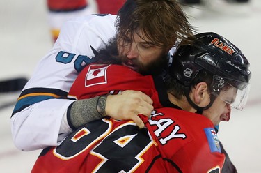 San Jose Sharks Brent Burns fights Garnet Hathaway of the Calgary Flames during NHL hockey in Calgary, Alta., on Monday, March 7, 2016. AL CHAREST/POSTMEDIA