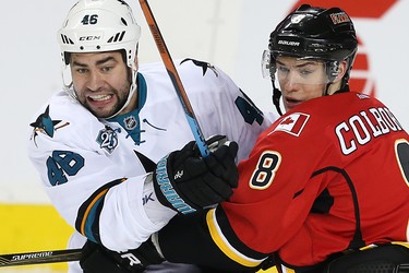 Calgary Flames Joe Colborne battles against Roman Polak of the San Jose Sharks during NHL hockey in Calgary, Alta., on Monday, March 7, 2016. AL CHAREST/POSTMEDIA