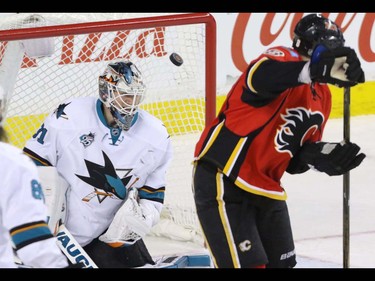 Calgary Flames Joe Colborne finally tips a shot past San Jose Sharks goalie Martin Jones in NHL hockey action at the Scotiabank Saddledome in Calgary, Alta. on Monday March 7, 2016. The Flames lost to the Sharks 2-1 in OT. Mike Drew/Postmedia