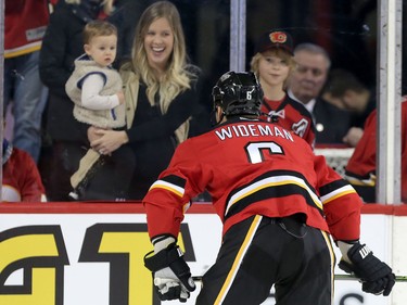 Dennis Wideman smiles at fans after being reinstated during warm-up before playing the Arizona Coyotes in NHL hockey action at the Scotiabank Saddledome in Calgary, Alta. on Friday March 11, 2016. Leah Hennel/Postmedia