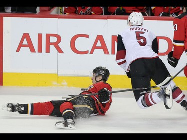 Calgary Flames Johnny Gaudreau, left collides with Arizona Coyotes Connor Murphy during NHL hockey action at the Scotiabank Saddledome in Calgary, Alta. on Friday March 11, 2016. Leah Hennel/Postmedia