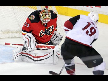 Calgary Flames goalie blocks a shot from  Arizona Coyotes Shane Doan during NHL hockey action at the Scotiabank Saddledome in Calgary, Alta. on Friday March 11, 2016. Leah Hennel/Postmedia