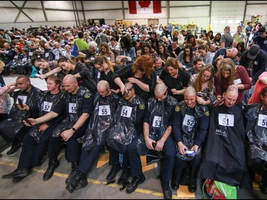 Finishing touches as firefighters and volunteers get their heads shaved as part of the Calgary Fire Department’s Record-Breaking Head Shave, a fundraising event that is attempting to break the Guinness World Record for most heads shaved simultaneously. The current record sits at 267 people. Over 300 people had their heads shaved in the event, unofficially breaking the record as well as raising over $100,000 for cancer research in Calgary, Ab., on Saturday March 12, 2016. Mike Drew/Postmedia