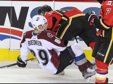 Calgary Flames Garnet Hathaway takes down Colorado Avalanche Mikkel Boedker in NHL hockey action at the Scotiabank Saddledome in Calgary, Alta. on Friday March 18, 2016. Mike Drew/Postmedia