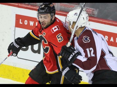 Calgary Flames Mark Giordano battles in the corner with Colorado Avalanche Jerome Iginla in NHL hockey action at the Scotiabank Saddledome in Calgary, Alta. on Friday March 18, 2016. Mike Drew/Postmedia