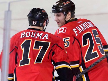 Calgary Flames Freddy Hamilton, right, is congratulated by Flames Lance Bouma after he scored a short-handed goal - the second on the same Flames penalty - against Colorado Avalanche Semyon Varlamov in NHL hockey action at the Scotiabank Saddledome in Calgary, Alta. on Friday March 18, 2016. It was Hamilton's first goal as a Flame. Mike Drew/Postmedia