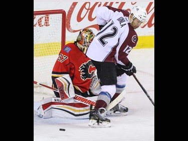 Calgary Flames goalie Joni Ortio gets his stick between the skates of  Colorado Avalanche Jerome Iginla in OT in NHL hockey action at the Scotiabank Saddledome in Calgary, Alta. on Friday March 18, 2016. The Flames lost to the Avalanche 4-3 in the shootout. Mike Drew/Postmedia