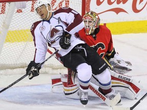 Calgary Flames goalie Joni Ortio gets his stick between the skates of  Colorado Avalanche Jerome Iginla in OT in NHL hockey action at the Scotiabank Saddledome in Calgary, Alta. on Friday March 18, 2016. The Flames lost to the Avalanche 4-3 in the shootout.