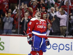 Washington Capitals left wing Alex Ovechkin (8), from Russia, celebrates his goal in the overtime period of an NHL hockey game against the Carolina Hurricanes, Tuesday, March 15, 2016, in Washington.