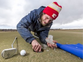 Assistant superintendent Nick Plantje digs ice out of a hold at Blue Devil Golf Club in Calgary on Tuesday, March 8, 2016.