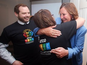 ATCO president and CEO Nancy Southern gets congratulatory hugs from colleagues, Dennis Gilson and Lorrie Grieve following the unveiling of the total of this year's EPIC (Employees Participating in Communities) charity fundraising on Wednesday. The company and it's employees raised $3.6million.