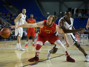 Calgary Dinos' Matt Letkeman, left, reaches for the ball in front of Carleton Ravens' Ryan Ejim during CIS men's national university basketball championship final game action in Vancouver, B.C., on Sunday, March 20, 2016.