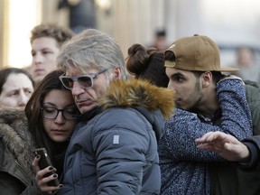 People gather at a makeshift memorial at Place de la Bourse  following attacks in Brussels on March 22, 2016.