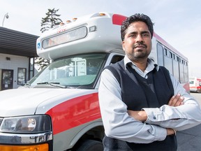 Amandeep Hunjan poses for a photo with a Calgary Transit shuttle bus in Calgary on Wednesday, March 23, 2016. Hunjan stopped a sex attack on a woman the night before when he happened upon while driving his route. (Lyle Aspinall/Postmedia Network)