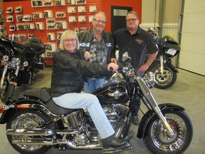 Cal 0319 Harley alone  Pictured with reason to smile at Calgary Harley Davidson are Karen Knapik and her husband Ted Knapik with dealership GM Rob Dzikewich (right) . The Knapik's won the Harley though the 18th Annual Bill Brooks Prostate Cancer Benefit raffle. First prize of a 2016 Camaro, courtesy Shaganappi GM,  was won by M. Albery who chose to turn the car in and donate roughly one-third of the value towards the 19th Annual Brooks Prostate Cancer Benefit. The 19th-and final Brooks Benefit-themed Billy Horror Picture Show, will be held Jan 27, 2017 at Hotel Arts.