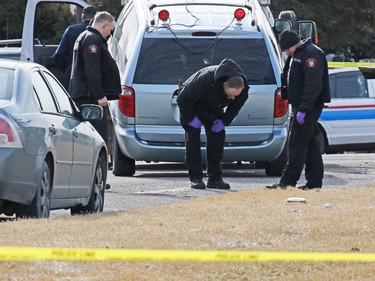 Police investigate a murder scene on the 100 block of Whiteview Road in Whitehorn Tuesday morning. A person was shot in the street at about 3:00 AM.