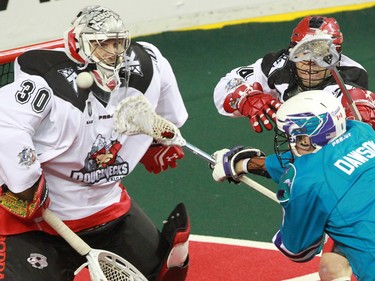 The Calgary Roughnecks goaltender Mike Poulin stopes this scoring chance by the Rochester Knighthawks'  Dan Dawson during National Lacrosse League action at the Scotiabank Saddledome in Calgary on Saturday March 5, 2016. Calgary lost 9-8 in overtime.