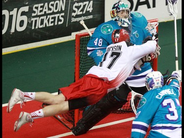 The Calgary Roughnecks' Curtis Dickson leaps to try scoring on Rochester Knighthawks goaltender Matt Vinc during National Lacrosse League action at the Scotiabank Saddledome in Calgary on Saturday March 5, 2016. Calgary lost 9-8 in overtime.