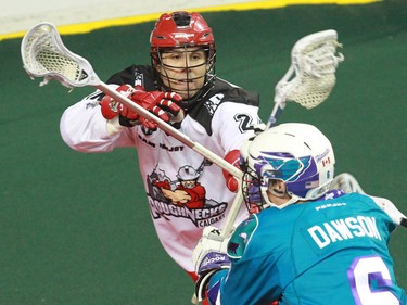 The Calgary Roughnecks' Scott Carnegie intercepts the Rochester Knighthawks' Dan Dawson during National Lacrosse League action at the Scotiabank Saddledome in Calgary on Saturday March 5, 2016. Calgary lost 9-8 in overtime.