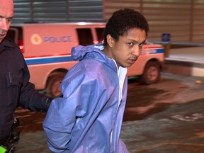 Alan Devon Bird of Calgary, charged in the murder of Jaime Orellana, is taken into the Calgary Police Arrest Processing Unit.
