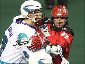 Greg Harnett of the Calgary Roughnecks jousts with Dan Dawson of the Rochester Knighthawks as the Drillers drop a 13-7 decision in front of over 13,000 fans March 14, 2015 at the Saddledome.