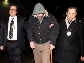 Will Rempel, a suspect in the Ryan Lane murder, is taken into the Court Services building in Calgary, Alberta on November 29, 2012.