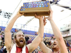 Calgary Dinos Matt Letkeman, left and Josh Owen-Thomas celebrate their win against the Thompson River Wolfpack during the Canada West Men's Basketball Finals in Calgary, Ab., on Saturday March 12, 2016.