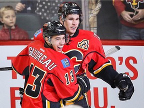 Calgary Flames Johnny Gaudreau and Sean Monahan celebrate after a goal by Jiri Hudler against the Anaheim Ducks during NHL hockey in Calgary, Alta. on Monday, February 15, 2016. Al Charest/Postmedia