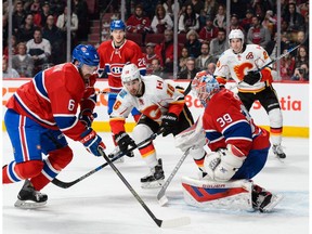 MONTREAL, QC - MARCH 20:  Greg Pateryn #6 of the Montreal Canadiens picks up a rebound left by goaltender Mike Condon #39 during the NHL game against the Calgary Flames at the Bell Centre on March 20, 2016 in Montreal, Quebec, Canada.