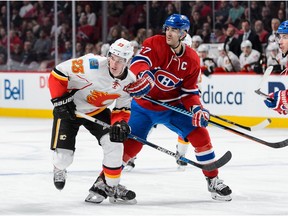 MONTREAL, QC - MARCH 20:  Max Pacioretty #67 of the Montreal Canadiens holds back Sean Monahan #23 of the Calgary Flames during the NHL game at the Bell Centre on March 20, 2016 in Montreal, Quebec, Canada.  The Calgary Flames defeated the Montreal Canadiens 4-1.