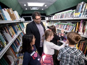 Mayor Naheed Nenshi talks with students from Alex Munro School March 10 as the Calgary Public Library launched two Book Trucks, 25 years after it shut down its beloved Bookmobiles.