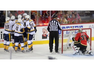 The Nashville Predators celebrate the tying goal on Calgary Flames goalie Joni Ortio sending the game into overtime at the Saddledome Wednesday March 9, 2016.  The Flames won 3-2 in OT.