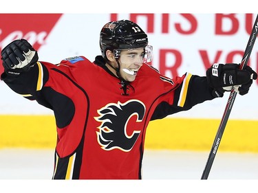 Calgary Flames Johnny Gaudreau celebrates after a goal by teammate Mikael Backlund against the Nashville Predators during NHL hockey in Calgary, Alta., on Wednesday, March 9, 2016.