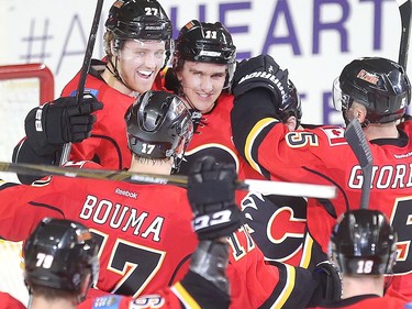Mikael Backlund is moobed by teammates after scoring his overtime goal, giving the Calgary Flames a 3-2 win over the Nashville Predators at the Saddledome Wednesday March 9, 2016.