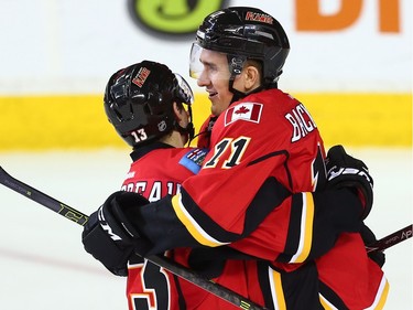 Calgary Flames Mikael Backlund celebrates with teammate Johnny Gaudreau after scoring against the Nashville Predators during NHL hockey in Calgary, Alta., on Wednesday, March 9, 2016.