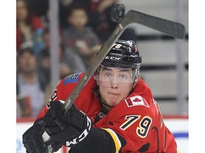 Micheal Ferland of Calgary Flames tries to bat down a flying puck against the Nashville Predators in the second period at the Saddledome Wednesday March 9, 2016.