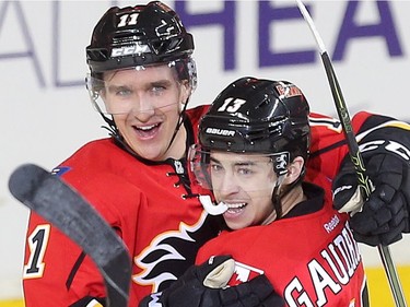 Mikael Backlund celebrates with Johnny Gaudreau as the pair combined on Backland's overtime goal, giving the Calgary Flames a 3-2 win over the Nashville Predators at the Saddledome Wednesday March 9, 2016.