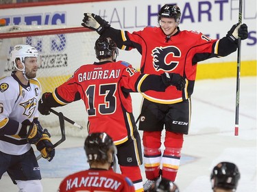 Mikael Backlund celebrates with Johnny Gaudreau as the pair combined on Backland's overtime goal, giving the Calgary Flames a 3-2 win over the Nashville Predators at the Saddledome Wednesday, March 9, 2016.