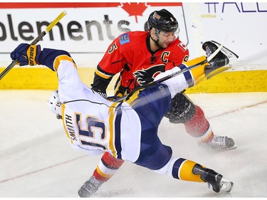 Nashville Predators Craig Smith collides with Mark Giordano of the Calgary Flames during NHL hockey in Calgary, Alta., on Wednesday, March 9, 2016.