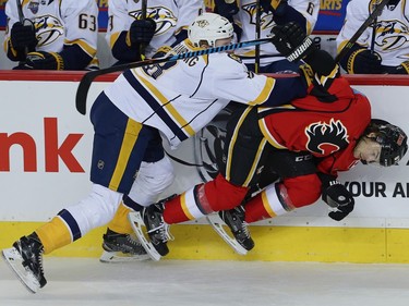 Calgary Flames Michael Frolik collides with Petter Granberg of the Nashville Predators during NHL hockey in Calgary, Alta., on Wednesday, March 9, 2016.