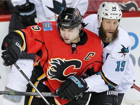 Calgary Flames Mark Giordano battles against Joe Thornton of the San Jose Sharks during NHL hockey in Calgary, Alta., on Monday, March 7, 2016. AL CHAREST/POSTMEDIA