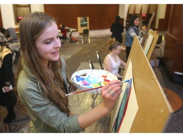 Sophie Barry of Henry Wisewood High School paints in the multi-media area of the Mayor's Lunch for Arts Champions Wednesday March 16, 2016 at the BMO Centre.  The artwork performance was part of the Telus Youth Arts Showcase of 150 music, dance and multi-media artists under 21 which opened the event. The awards are organized by Calgary Arts Development recognizing seven legacy artist award winners.