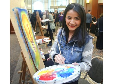 Frozan Hydari of Henry Wisewood High School paints in the multi-media area of the Mayor's Lunch for Arts Champions Wednesday March 16, 2016 at the BMO Centre.  The artwork performance was part of the Telus Youth Arts Showcase of 150 music, dance and multi-media artists under 21 which opened the event. The awards are organized by Calgary Arts Development recognizing seven legacy artist award winners.