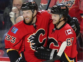 Calgary Flames Michael Frolik celebrates with teammate Jakub Nakladal after scoring against the Winnipeg Jets during NHL hockey in Calgary, Alta., on Wednesday, March 16, 2016.